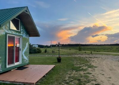Colourful sunset over the Alberta countryside beside the French Creek RV rental cabin with private deck and glass doors in Fawcett, Alberta.